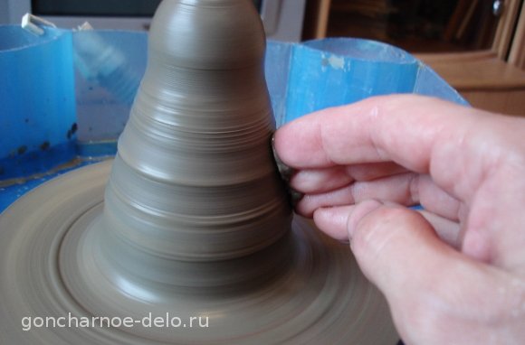 Pottery: trim the cone with your fingers